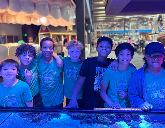 Many students posing for a photo at Science Museum Oklahoma while on a field trip.