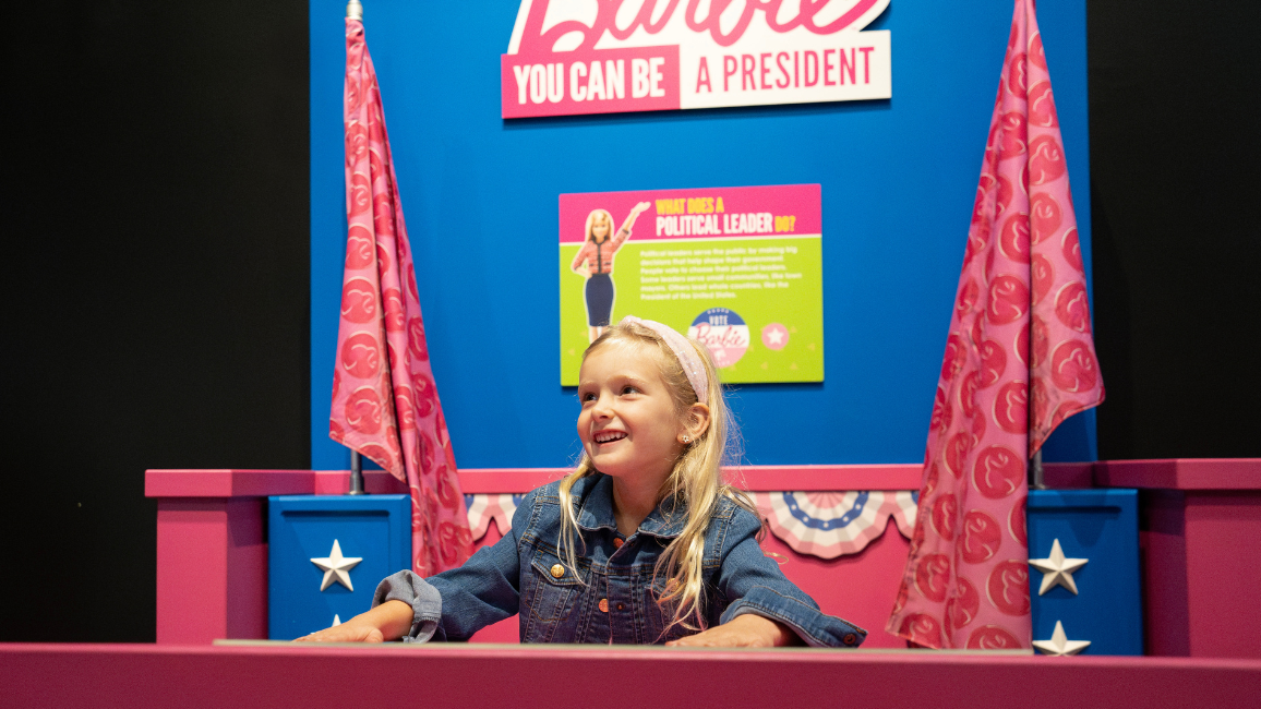 A girl plays at an exhibit called Barbie at Science museum oklahoma