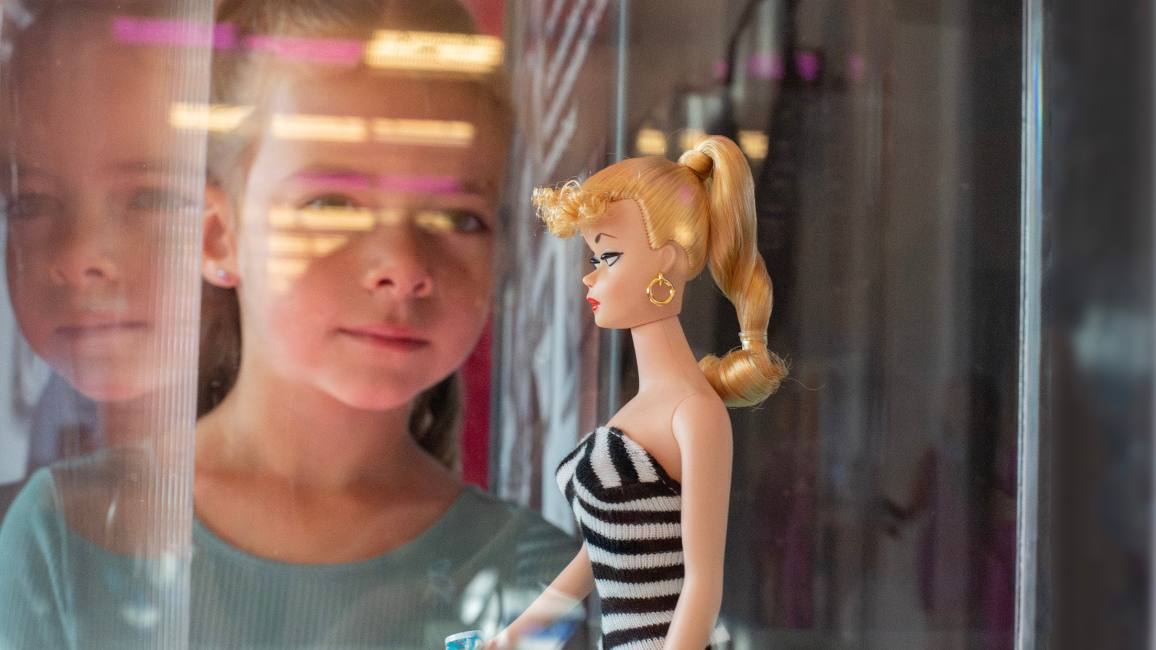 A girl plays at an exhibit called Barbie at Science museum oklahoma