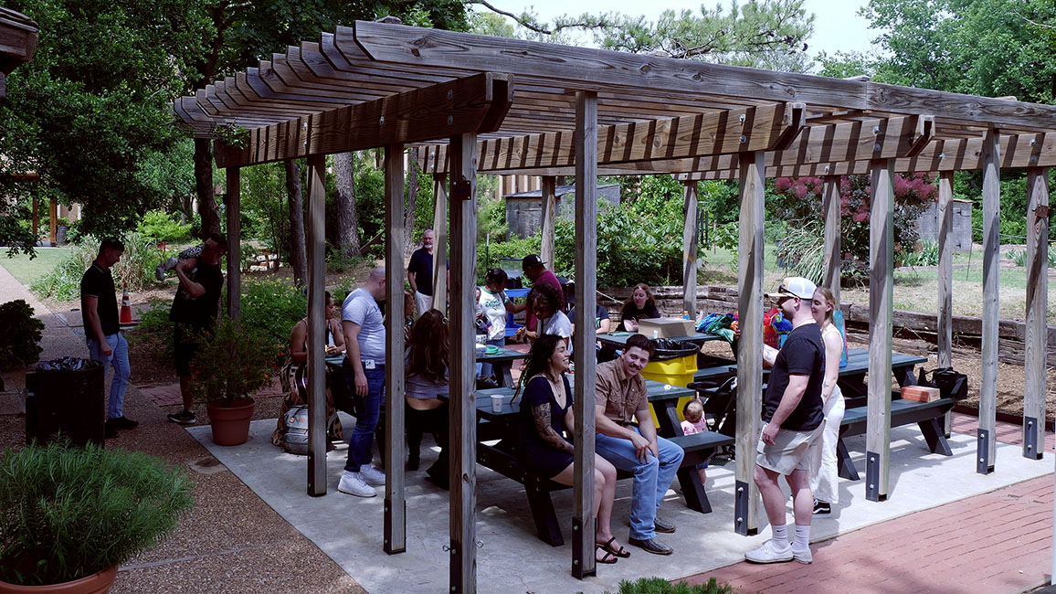 A group of family and friends meet to have a birthday outside in the gardens at Science Museum Oklahoma.