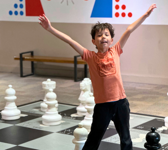 A child celebrates at science museum oklahoma among the exhibits.