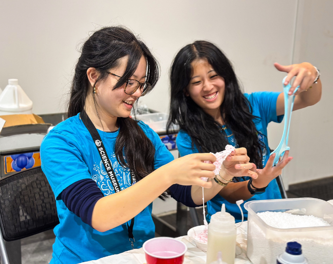 Two teens make slime as a part of the teen apprentice program at science museum oklahoma