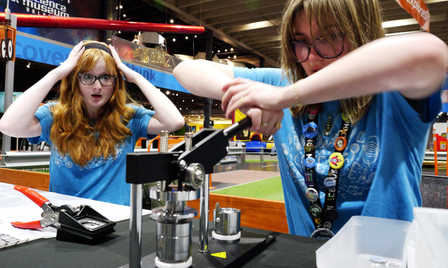 Two teens participate in an activity at science museum oklahoma