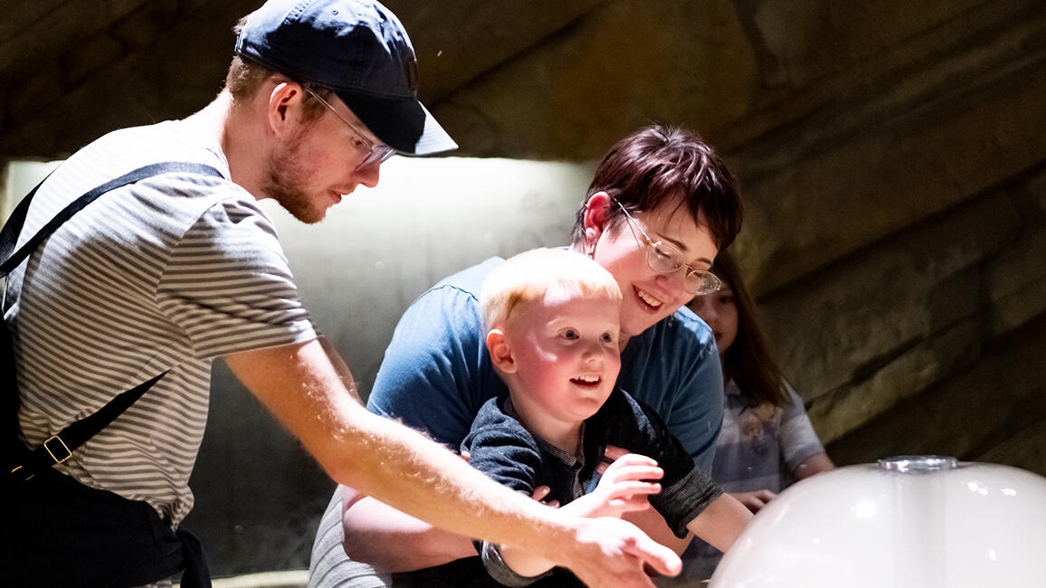 Family explores bubbles and airflow in CurioCity at Science Museum Oklahoma, a STEM exhibit designed for imaginative learning.