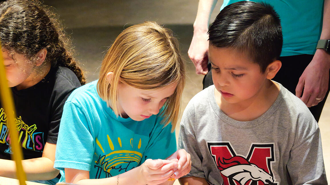 Young children engaging in hands-on STEM learning activity during a field trip to Science Museum Oklahoma.