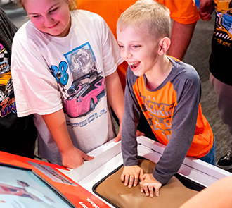 A child excitedly engages with a hands-on exhibit at Science Museum Oklahoma.