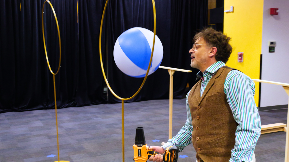 A guest explores fundraising opportunities at Elemental Ball at Science Museum Oklahoma