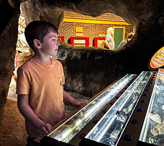 A boy explores interactive light displays in the hands-on Energy Quest exhibit at Science Museum Oklahoma.