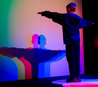 Child explores light, color, and shadows in the LightMinded exhibit at Science Museum Oklahoma’s hands-on science center.