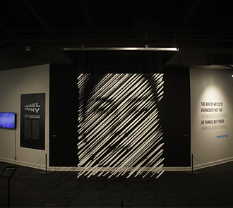 Science Museum Oklahoma's smART Space exhibit featuring a large-scale optical illusion portrait by artist Michael Murphy.