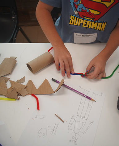 A child builds a craft in camps at Science Museum Oklahoma.