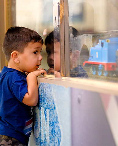 boy looking through a window