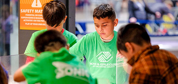 Students from the Boys and Girls Club participate in a hands-on STEM activity during a field trip to Science Museum Oklahoma.