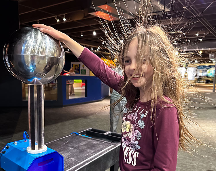 Girls experiences electric static experiencing Member night at Science Museum Oklahoma.