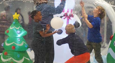 Kids experience joy in a snow globe at Winter Wonderlab event hosted by Science Museum Oklahoma.