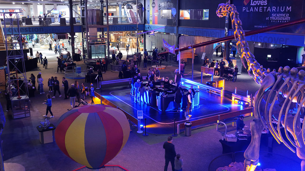 Guests enjoy an after-hours full museum rental at Science Museum Oklahoma, featuring exhibits, custom lighting, and interactive experiences.