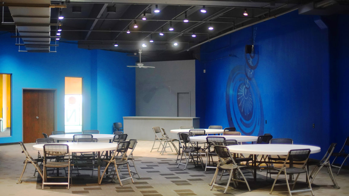 A multi-use room that is spacious, has audio and video hookups, and still has easy access to the rest of the museum.