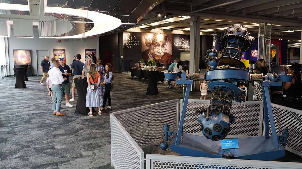 Groups of people enjoying a cocktail hour at a private event at Science Museum Oklahoma.