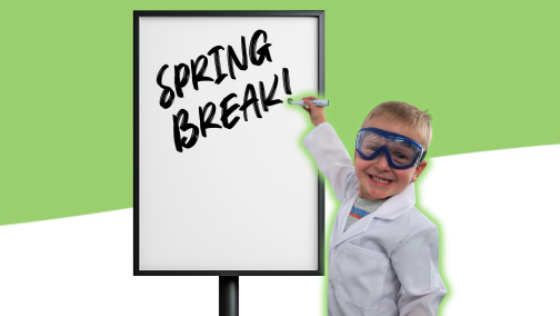 Little boy writes Spring Break on a whhite board dressed as a scientist at Science Museum Oklahoma camps