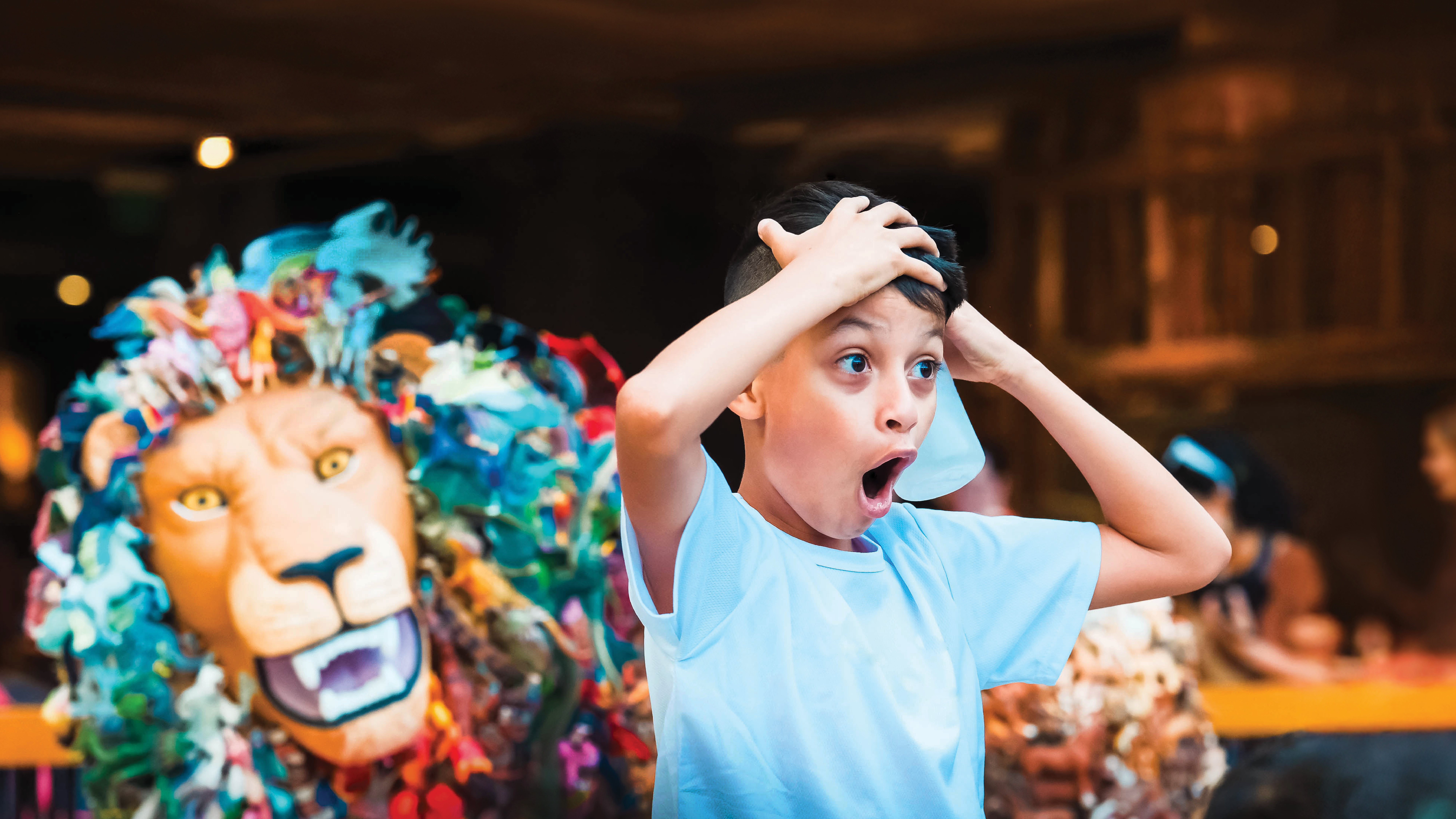 Boy has shocked face with lion in the background. Synergy impact report 2026