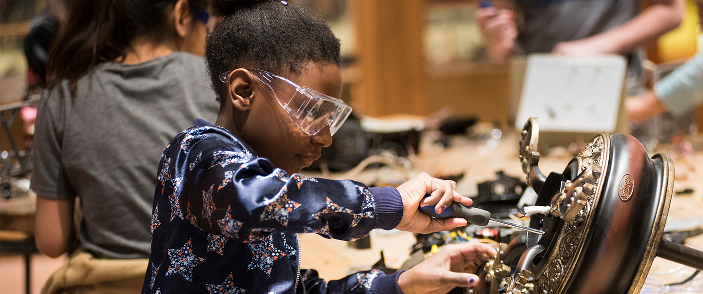 Girl tinkers with robotics while learning at Science Museum Oklahoma.