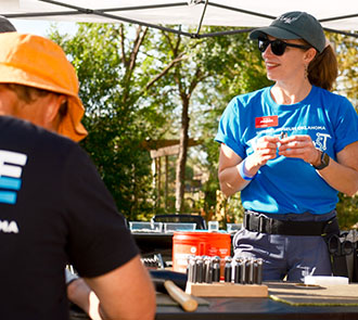 A volunteer stands smiling at Science Museum Oklahoma’s free community tinkering event Discoverfest.