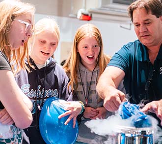 Middle school students watch a liquid nitrogen demonstration during Science Museum Oklahoma’s Women in STEAM event, part of a hands-on science education program.