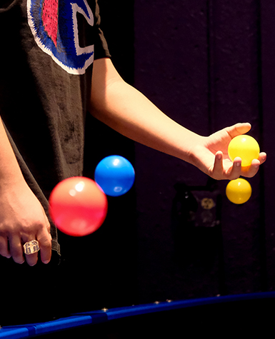 boy juggling balls
